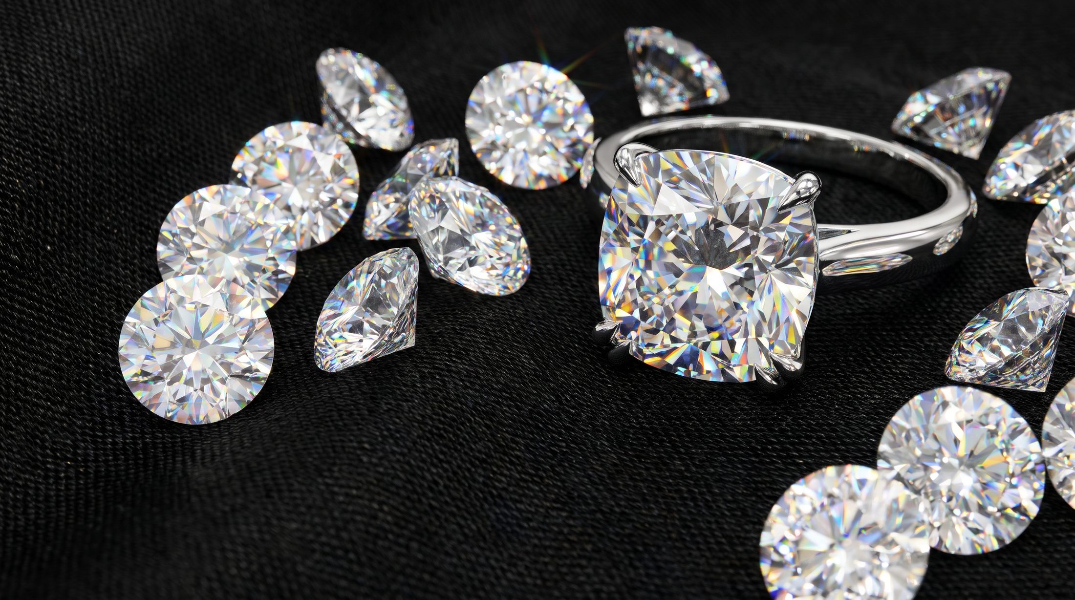Brilliant cut diamonds and a cushion cut solitaire on black silk
